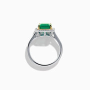 The Brasilica 14K Two Tone Gold Emerald and Diamond Ring showcases a large rectangular green emerald in a gold prong setting, accented by a halo of clear diamonds and baguette-cut diamonds along the band.
