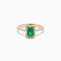 The 14K Yellow Gold Emerald and Diamond Ring showcases a rectangular emerald center stone, accented by white diamonds around the gemstone and along the band.