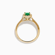 The 14K Yellow Gold Emerald and Diamond Ring showcases a rectangular emerald center stone, accented by white diamonds around the gemstone and along the band.