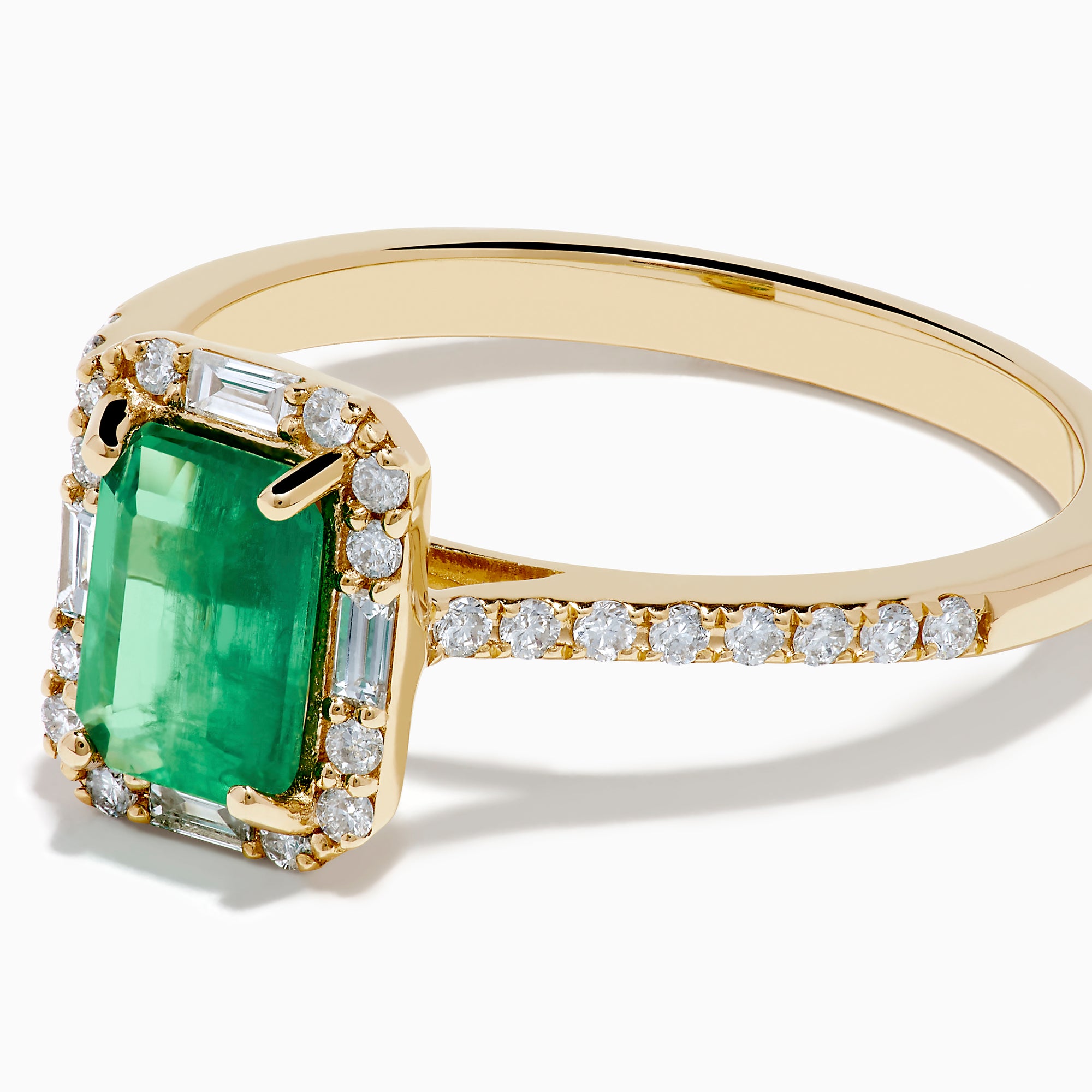 The 14K Yellow Gold Emerald and Diamond Ring showcases a rectangular emerald center stone, accented by white diamonds around the gemstone and along the band.