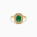 The Brasilica 14K Yellow Gold Emerald and Diamond Ring showcases a rectangular green emerald center, surrounded by a halo of sparkling round white diamonds, all set in yellow gold and displayed on a white background.