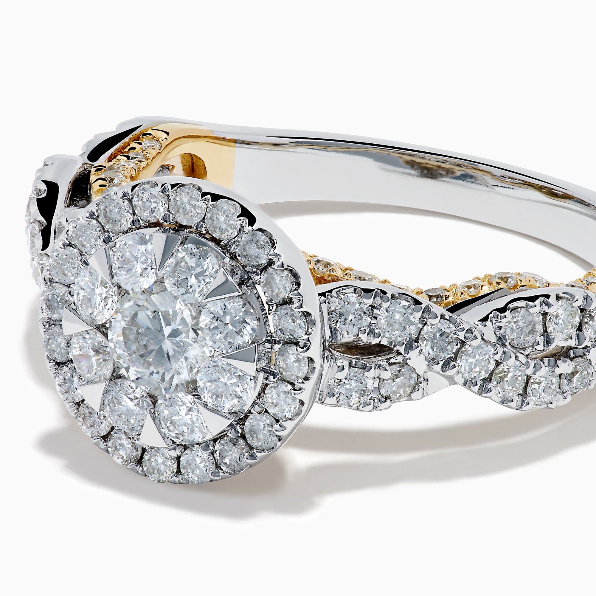 The 14K Two Tone Gold Diamond Cluster Engagement Ring features a central round diamond cluster, surrounded by a halo of smaller diamonds on an intricately designed band embellished with more diamonds.