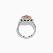 The 14K Two Tone Gold Pave Pink and White Diamond Halo Ring features a square center cluster of pink stones, bordered by white diamonds on a two-tone gold band, displayed against a white background.