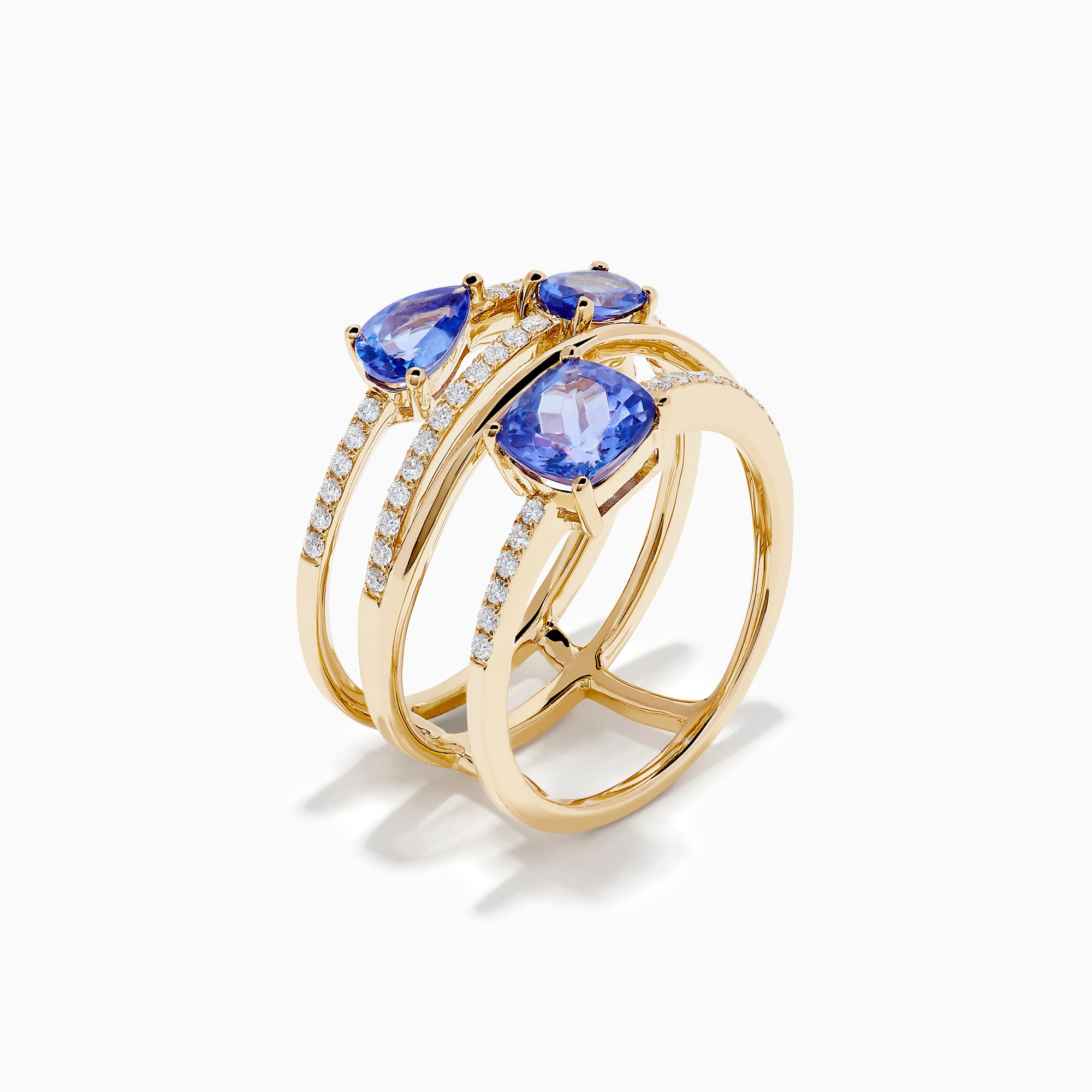 The 14K Yellow Gold Tanzanite and Diamond Multi-Row Statement Ring features three stacked bands set with white diamonds and pear, oval, and cushion-cut blue tanzanite gemstones.