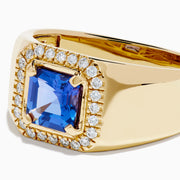 Men's 14K Yellow Gold Step Cut Tanzanite and Diamond Halo Signet Ring featuring a square blue gemstone center with a double diamond halo, shown on a plain white background.