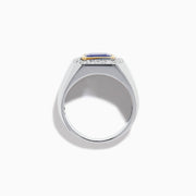 The Men's 14K Two Tone Gold East West Emerald Cut Tanzanite and Diamond Ring features a rectangular blue tanzanite set in a gold bezel, framed by white diamonds, all beautifully crafted against a plain white background.