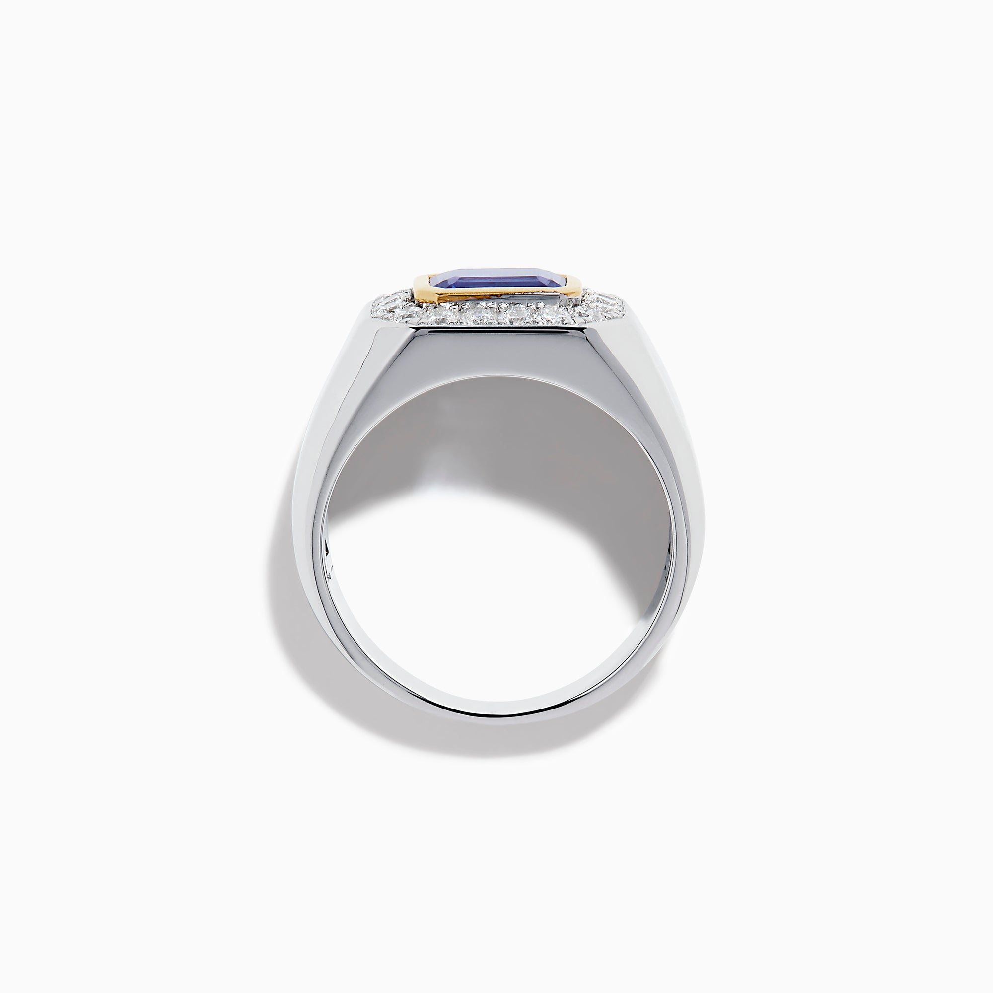 The Men's 14K Two Tone Gold East West Emerald Cut Tanzanite and Diamond Ring features a rectangular blue tanzanite set in a gold bezel, framed by white diamonds, all beautifully crafted against a plain white background.