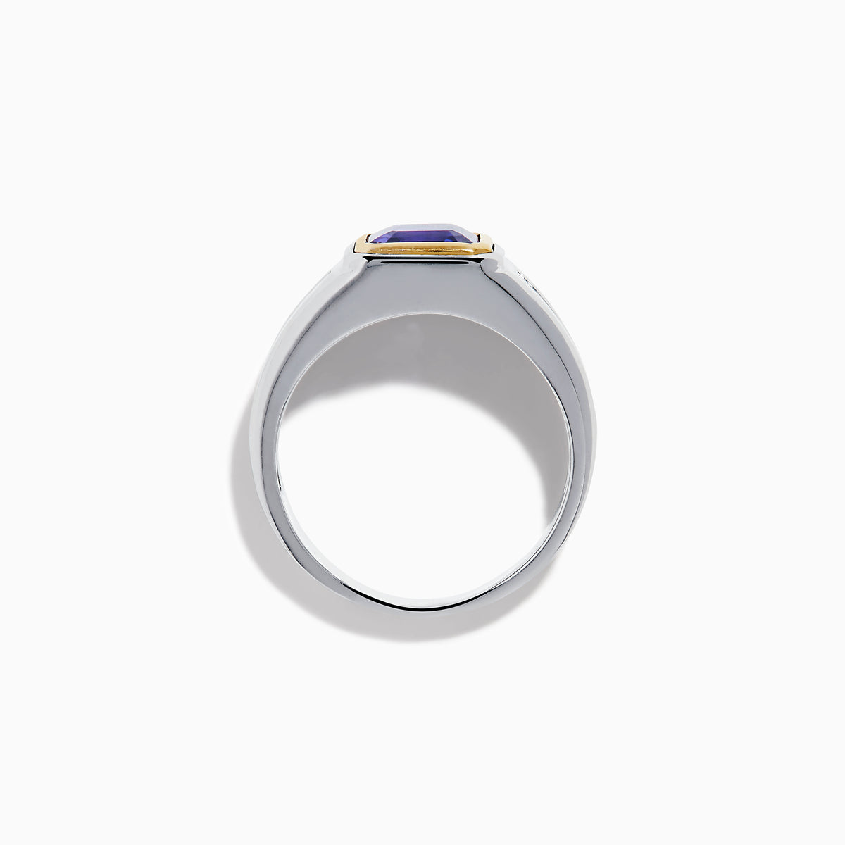 The Men's 14K Two Tone Gold Bezel Set Tanzanite and Diamond Signet Ring features a bold square tanzanite center, bordered by a gold bezel, and accented with small round diamonds on each side of the band.