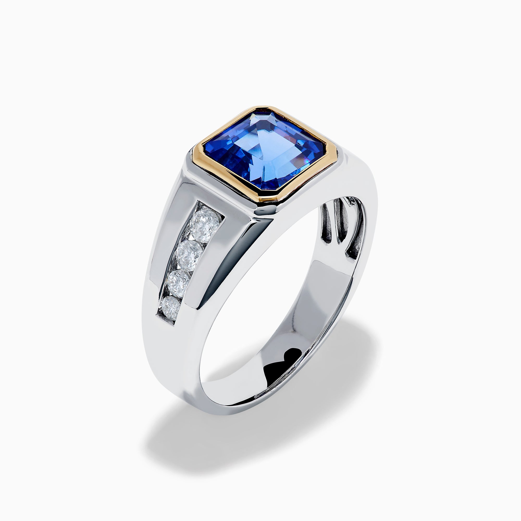 The Men's 14K Two Tone Gold Bezel Set Tanzanite and Diamond Signet Ring features a bold square tanzanite center, bordered by a gold bezel, and accented with small round diamonds on each side of the band.