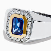 The Men's 14K Two Tone Gold Tanzanite and Diamond Bezel Halo Ring features a rectangular blue tanzanite framed by dazzling white diamonds, set on a bold band for a standout look.