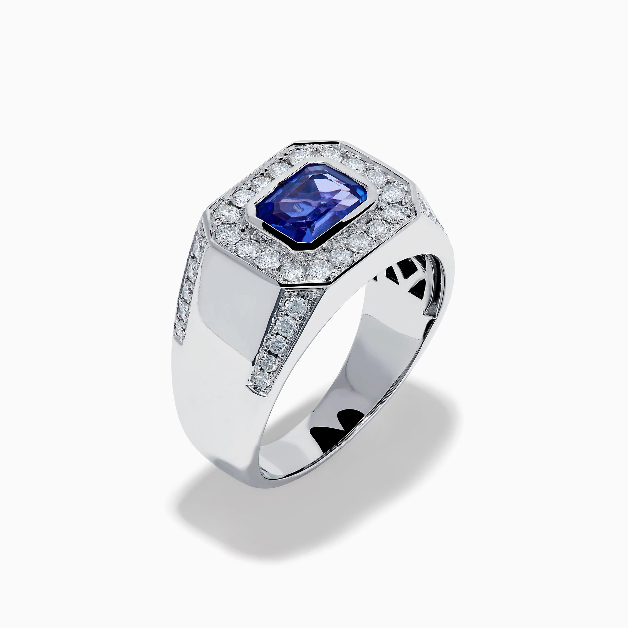 The Men's 14K White Gold East West Tanzanite and Diamond Signet Ring features a rectangular tanzanite center set among round diamonds in a bold geometric design, showcased on a white background.