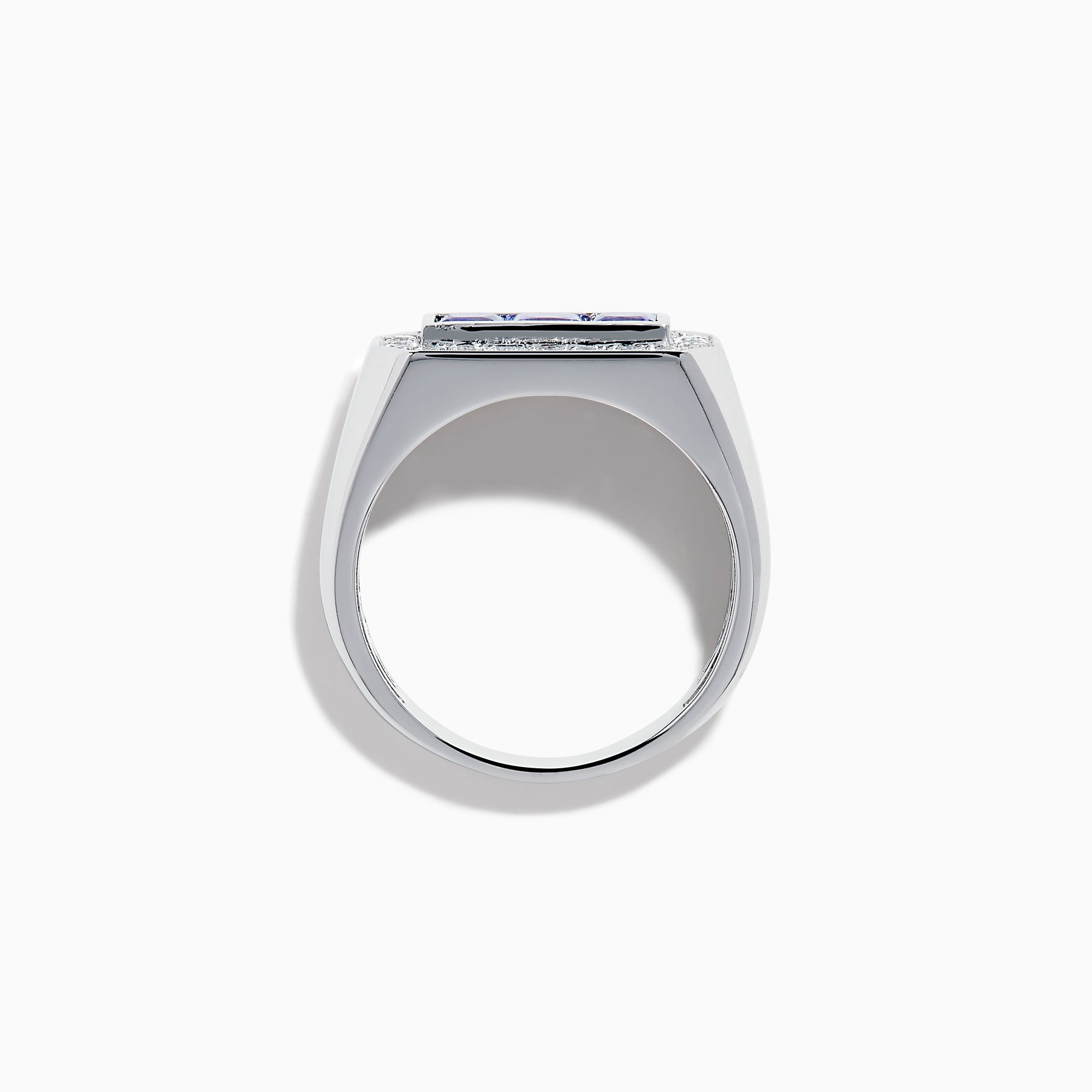 The Men's 14K White Gold Princess Cut Tanzanite and Diamond Signet Ring features three princess-cut tanzanites at the center, framed by small round white diamonds in an octagonal border.