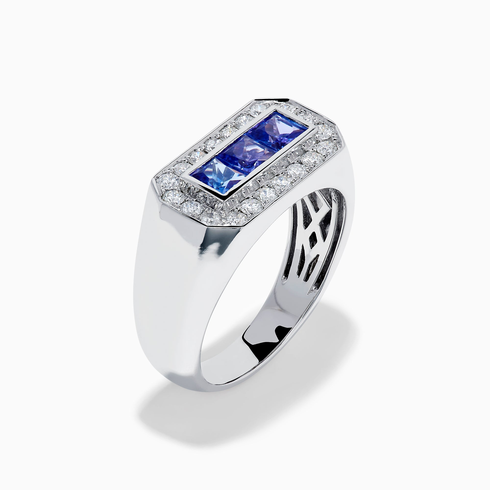 The Men's 14K White Gold Princess Cut Tanzanite and Diamond Signet Ring features three princess-cut tanzanites at the center, framed by small round white diamonds in an octagonal border.