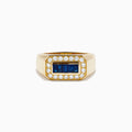 The Men's 14K Yellow Gold Diamond and Blue Sapphire Signet Ring features a bold rectangular center of blue sapphires, framed by round white diamonds in a symmetrical yellow gold setting.