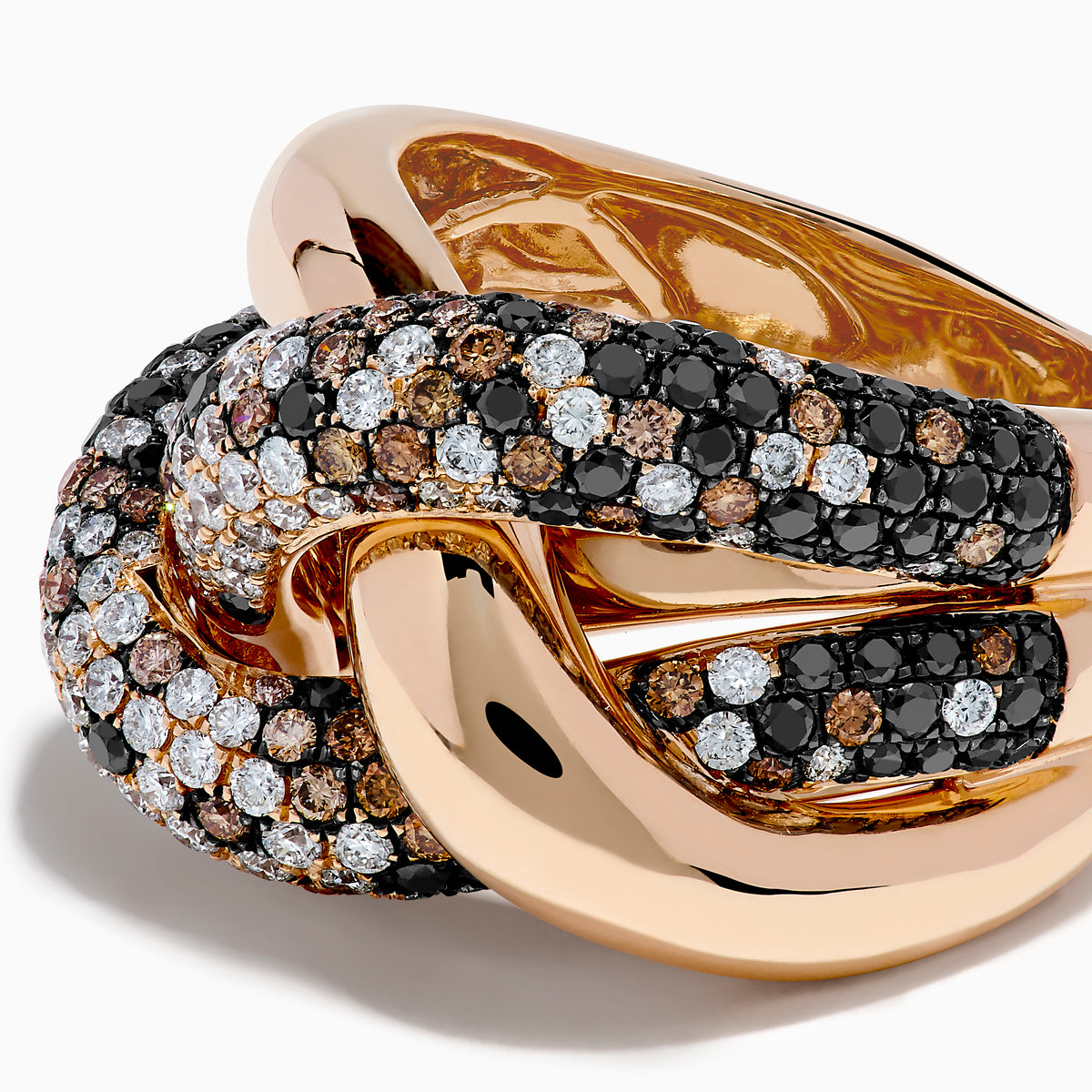 The 14K Rose Gold Black, White and Espresso Intertwined Ring features three interlocking bands: polished rose gold, white diamonds, and brown/black diamonds, shown against a white background.