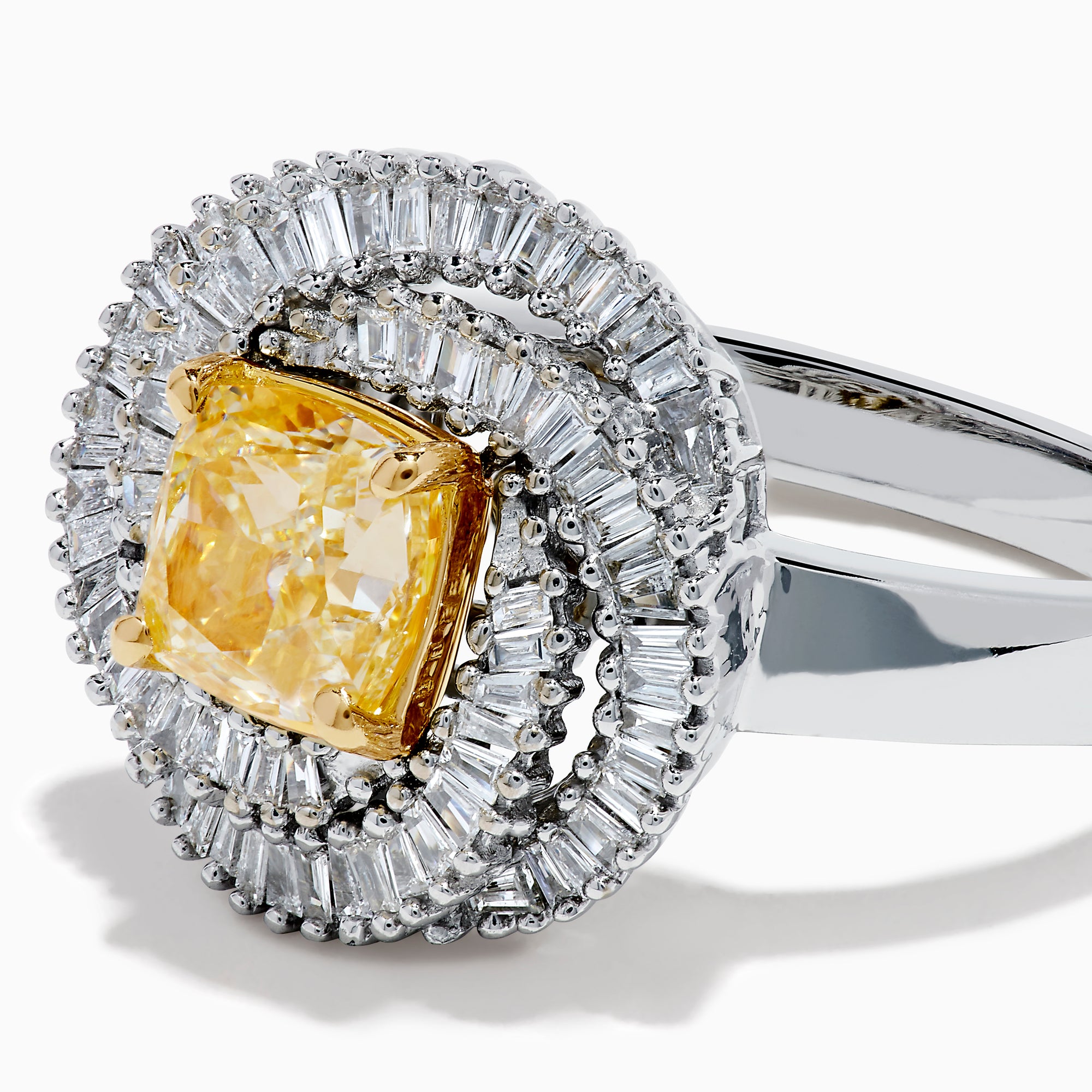 The 14K Two Tone Yellow Gold Yellow and White Diamond Halo Spiral Ring features a central square yellow gemstone, surrounded by a diamond halo with two rows of white diamonds in a sparkling circular spiral design.