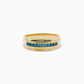 The Mens Bella Bleu 14K Yellow Gold Blue Diamond Ring features a row of small, round blue diamonds set in the center and is displayed on a white background.
