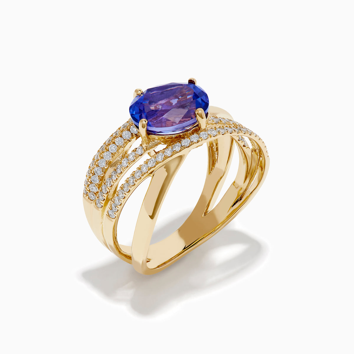 The 14K Yellow Gold Tanzanite and Diamond Crossover Ring showcases an oval tanzanite center stone accented by intersecting diamond-encrusted bands for a brilliant, modern look.