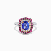 The 14K Two Tone Gold Tanzanite, Diamond, and Pink Sapphire Cushion Halo Ring features a striking tanzanite center, framed by sparkling diamonds and a halo of vivid pink sapphires on a sleek white background.