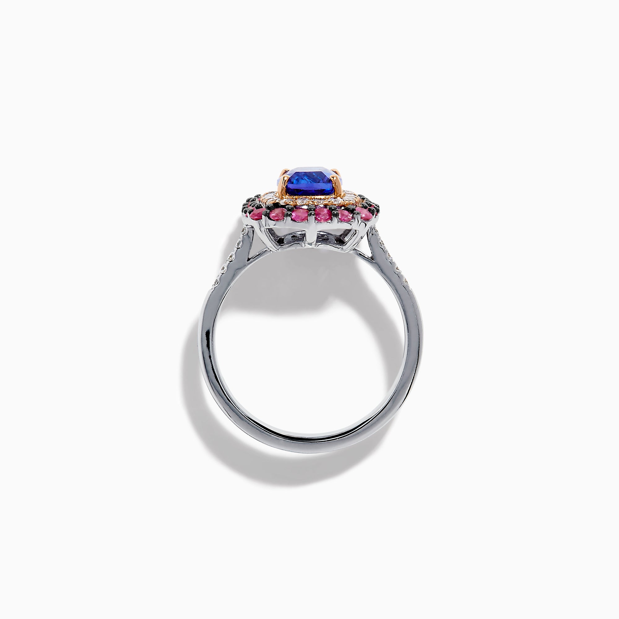 The 14K Two Tone Gold Tanzanite, Diamond, and Pink Sapphire Cushion Halo Ring features a striking tanzanite center, framed by sparkling diamonds and a halo of vivid pink sapphires on a sleek white background.