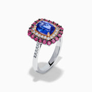 The 14K Two Tone Gold Tanzanite, Diamond, and Pink Sapphire Cushion Halo Ring features a striking tanzanite center, framed by sparkling diamonds and a halo of vivid pink sapphires on a sleek white background.