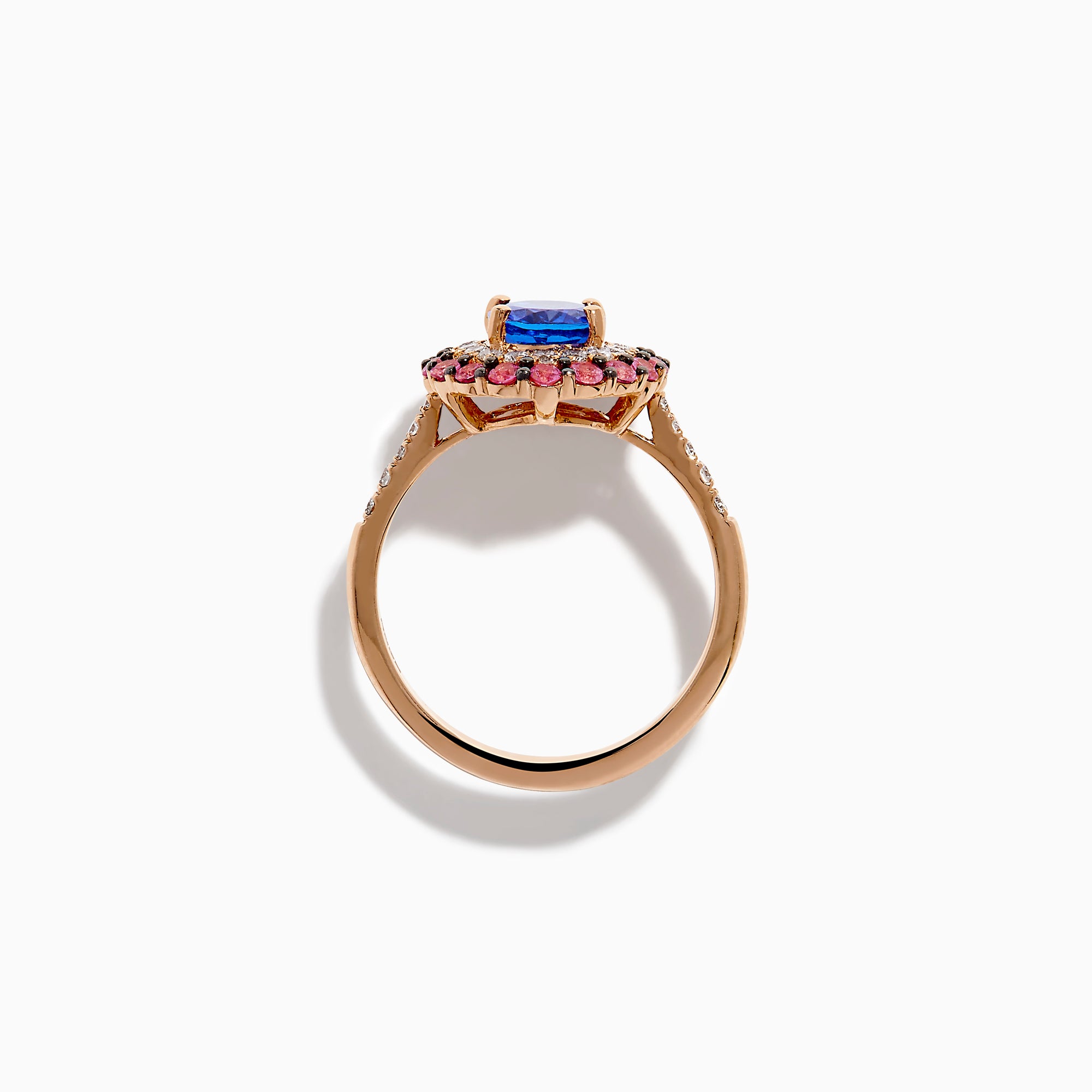 The 14K Rose Gold Tanzanite, Diamond, and Pink Sapphire Oval Halo Ring features a large oval blue tanzanite center, double halos of white diamonds and pink sapphires, plus diamond accents on the band.