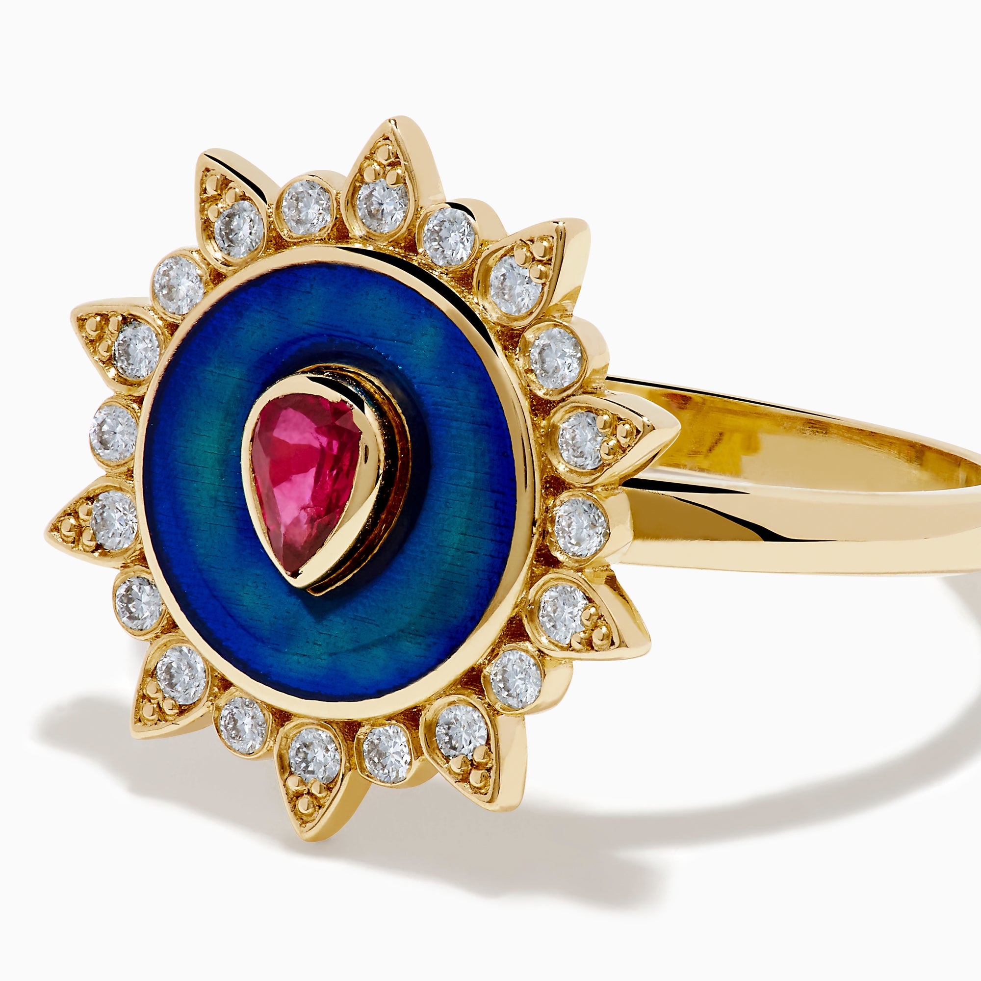 The 14K Yellow Gold Ruby, Diamond, and Enamel Ring showcases a central teardrop ruby, a blue enamel circle, and an outer border of round diamonds in a sunburst design.