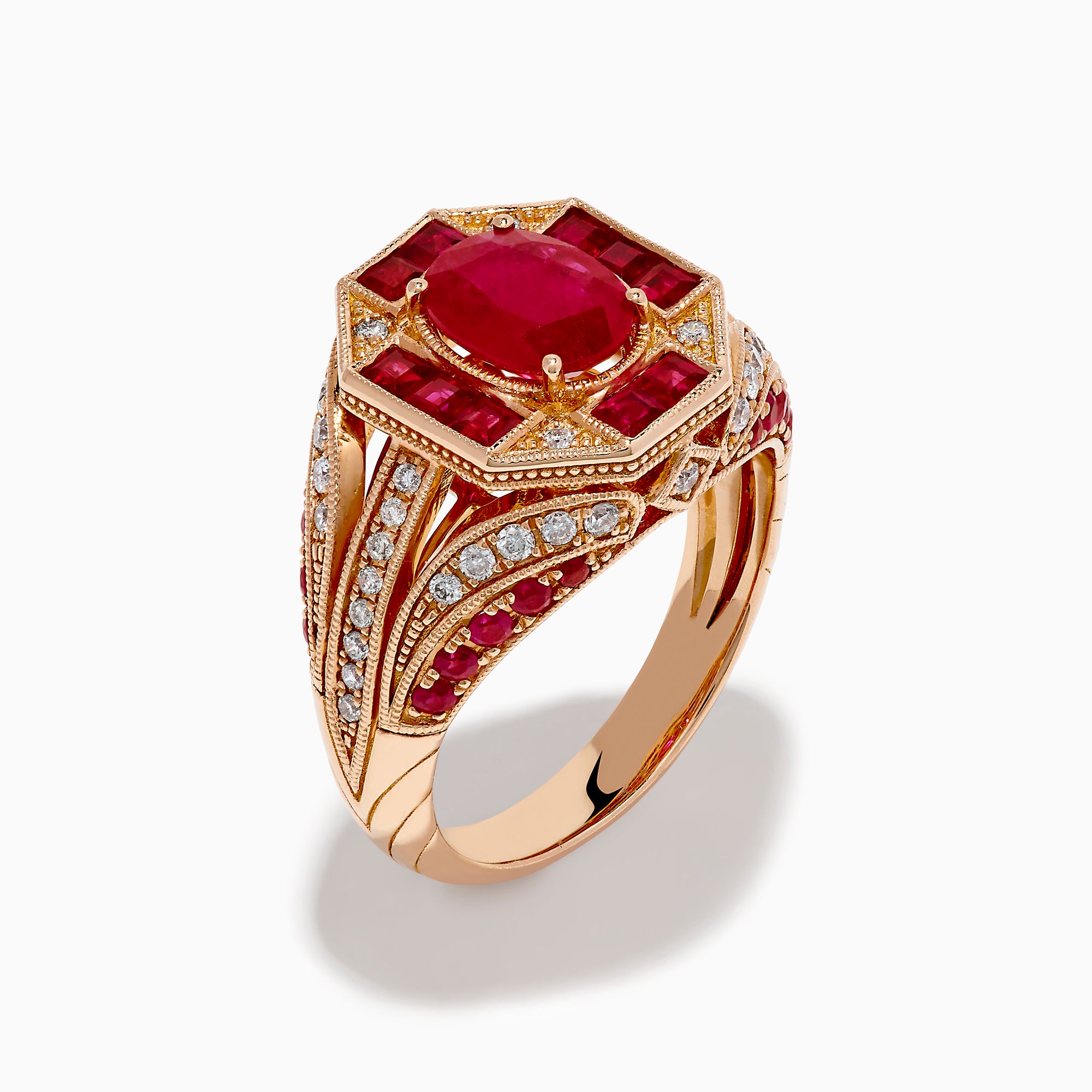 The 14K Rose Gold Ruby and Diamond Art Deco Ring features an oval ruby center, surrounded by square and rectangular rubies and small white diamonds in a geometric, ornate rose gold setting.