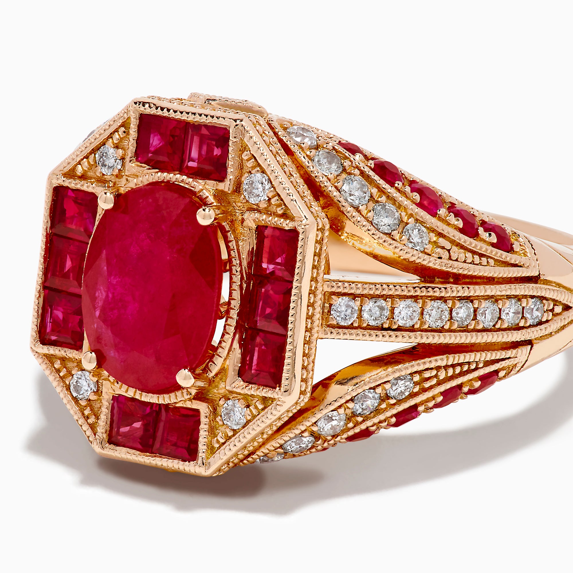 The 14K Rose Gold Ruby and Diamond Art Deco Ring features an oval ruby center, surrounded by square and rectangular rubies and small white diamonds in a geometric, ornate rose gold setting.