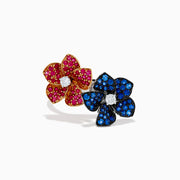 The 14K Two Tone Ruby, Sapphire, and Diamond Floral Bypass Ring features jeweled floral designs with ruby, sapphire, and diamond accents, displayed elegantly on a white background.