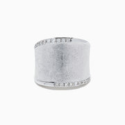 The 925 Sterling Silver Diamond Accented Wide Ring showcases a matte, textured band bordered by curved rows of sparkling diamond accents along its top and bottom edges.