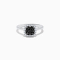 The 14K White Gold White and Black Diamond Ring features a square cluster of black diamonds at the center, bordered by small white gemstones on a sleek band, shown against a white background.