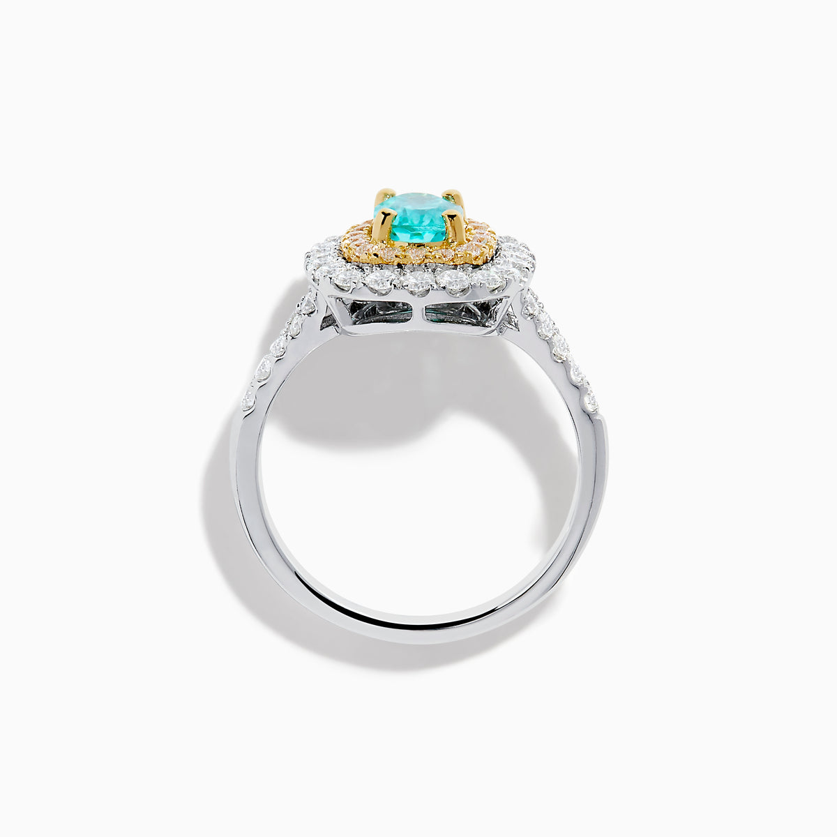 The 18K Two Tone Gold Paraiba and Diamond Double Halo Ring features an oval Paraiba centerpiece, surrounded by radiant yellow and white diamonds in a double halo, creating a striking layered effect.