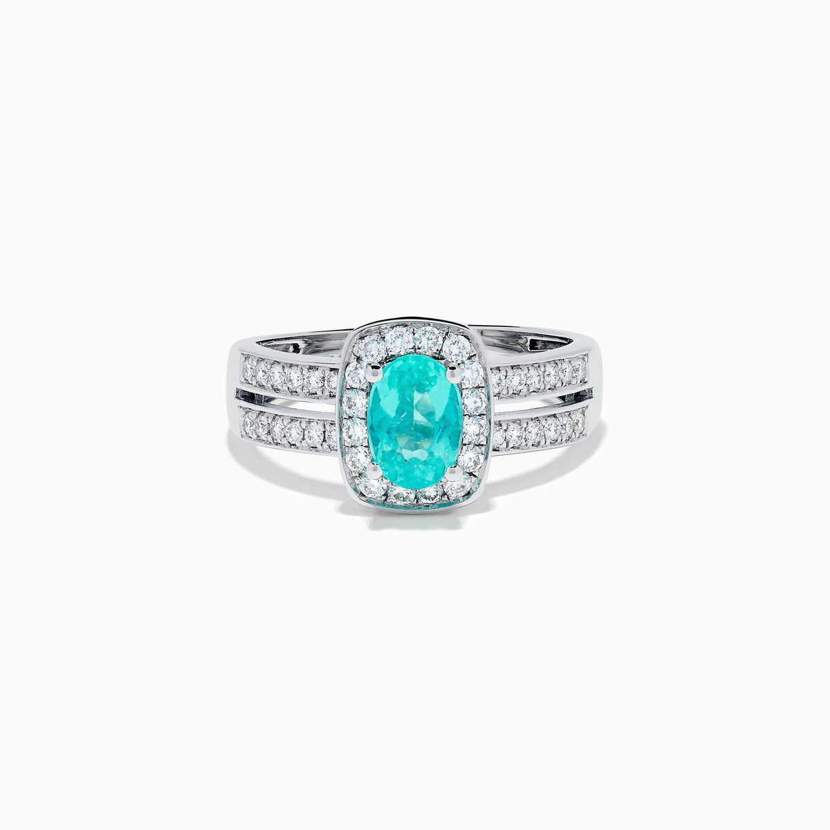The 18K White Gold Paraiba and Diamond Halo Ring features an oval Paraiba center gemstone, encircled by sparkling diamonds and set on an elegant split shank band adorned with additional diamonds.