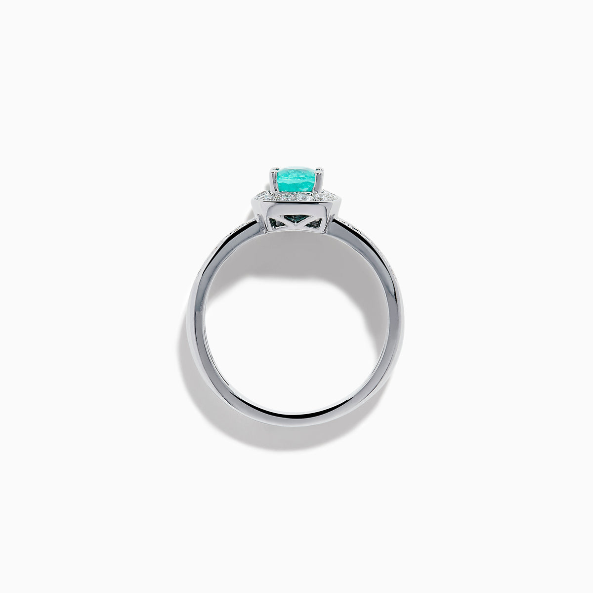 The 18K White Gold Paraiba and Diamond Halo Ring features an oval Paraiba center gemstone, encircled by sparkling diamonds and set on an elegant split shank band adorned with additional diamonds.