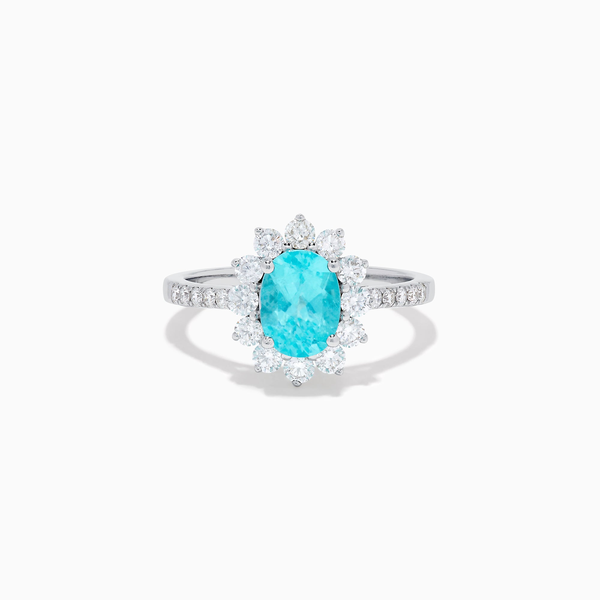 The 14K White Gold Paraiba and Diamond Halo Ring showcases an oval-shaped Paraiba gemstone at the center, encircled by a sparkling diamond halo with additional diamonds adorning the band.