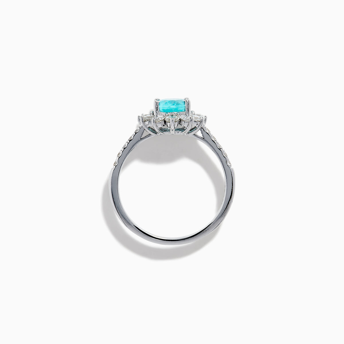 The 14K White Gold Paraiba and Diamond Halo Ring showcases an oval-shaped Paraiba gemstone at the center, encircled by a sparkling diamond halo with additional diamonds adorning the band.