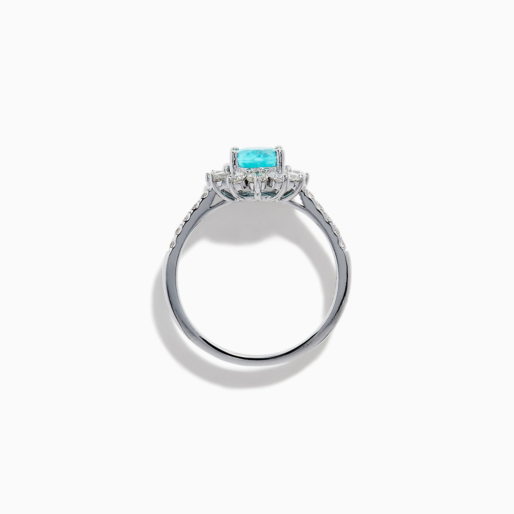 The 14K White Gold Paraiba and Diamond Halo Ring showcases an oval-shaped Paraiba gemstone at the center, encircled by a sparkling diamond halo with additional diamonds adorning the band.