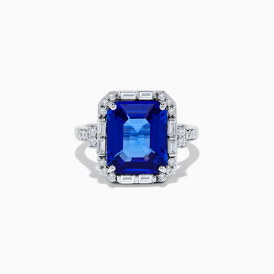 The Nahla Siri 14K White Gold Emerald Cut Tanzanite and Diamond Ring features a large emerald-cut tanzanite center, accented by baguette and round diamonds, displayed on a white background.