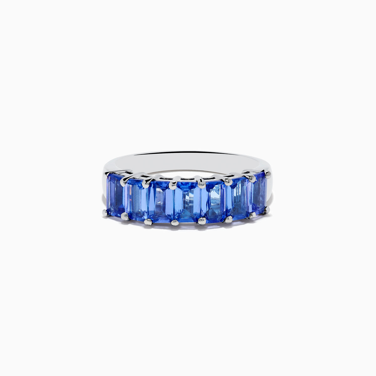 The Nahla Siri 925 Silver Tanzanite Band Ring features a row of rectangular blue tanzanites set across the top half of the band, crafted in refined sterling silver.