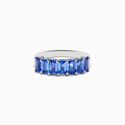 The Nahla Siri 925 Silver Tanzanite Band Ring features a row of rectangular blue tanzanites set across the top half of the band, crafted in refined sterling silver.