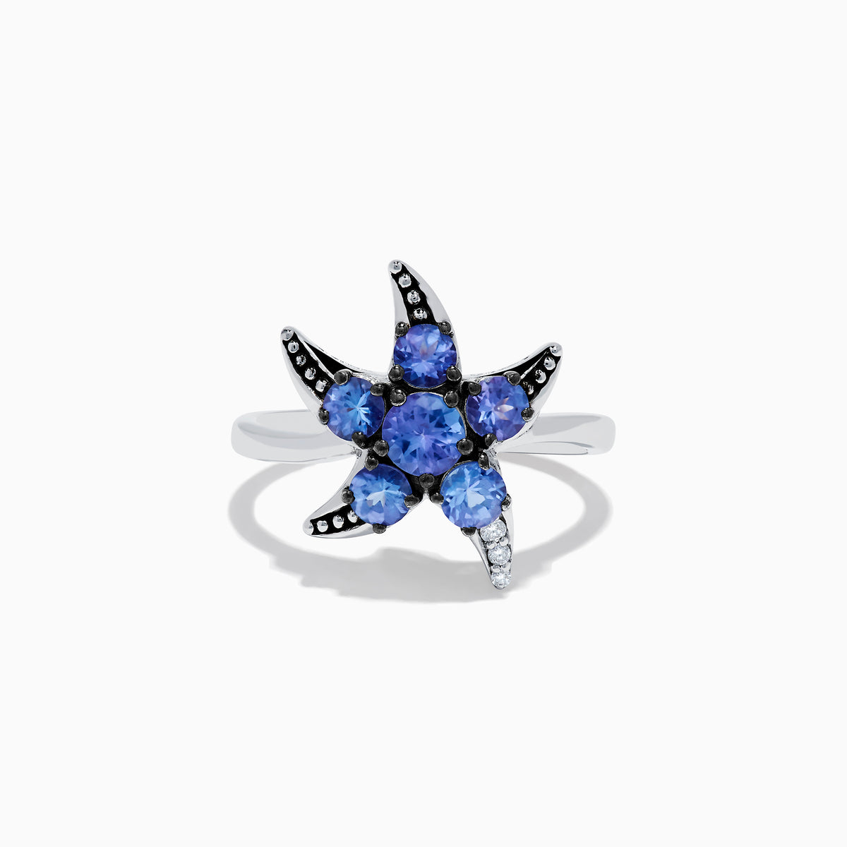 The 925 Sterling Silver Tanzanite and Diamond Starfish Ring features five round tanzanite gemstones and sparkling diamonds along one arm, displayed on a white background.