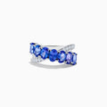 The Nahla 14K White Gold Tanzanite and Diamond Criss Cross Ring features oval tanzanites set diagonally across the band, accented by sparkling diamonds on one side.