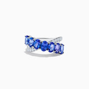 The Nahla 14K White Gold Tanzanite and Diamond Criss Cross Ring features oval tanzanites set diagonally across the band, accented by sparkling diamonds on one side.