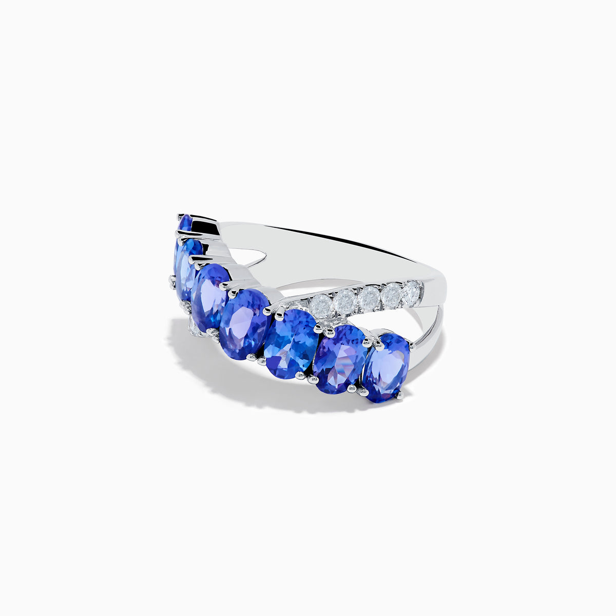 The Nahla 14K White Gold Tanzanite and Diamond Criss Cross Ring features oval tanzanites set diagonally across the band, accented by sparkling diamonds on one side.