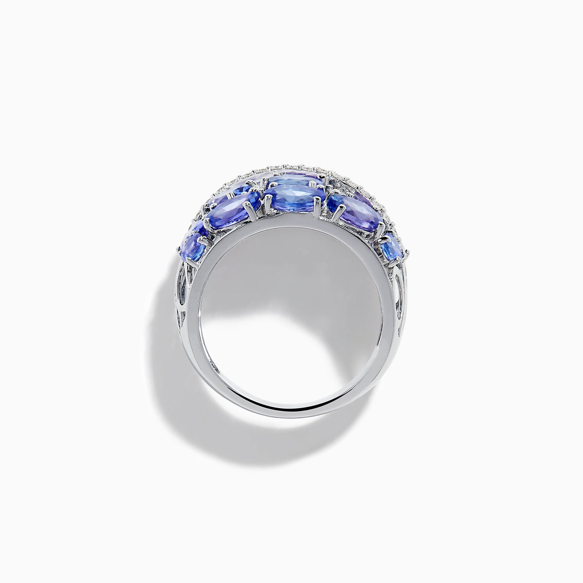 The 14K White Gold Tanzanite and Diamond Statement Ring features multiple oval blue-violet tanzanites and round white diamonds in an elegant, layered design.