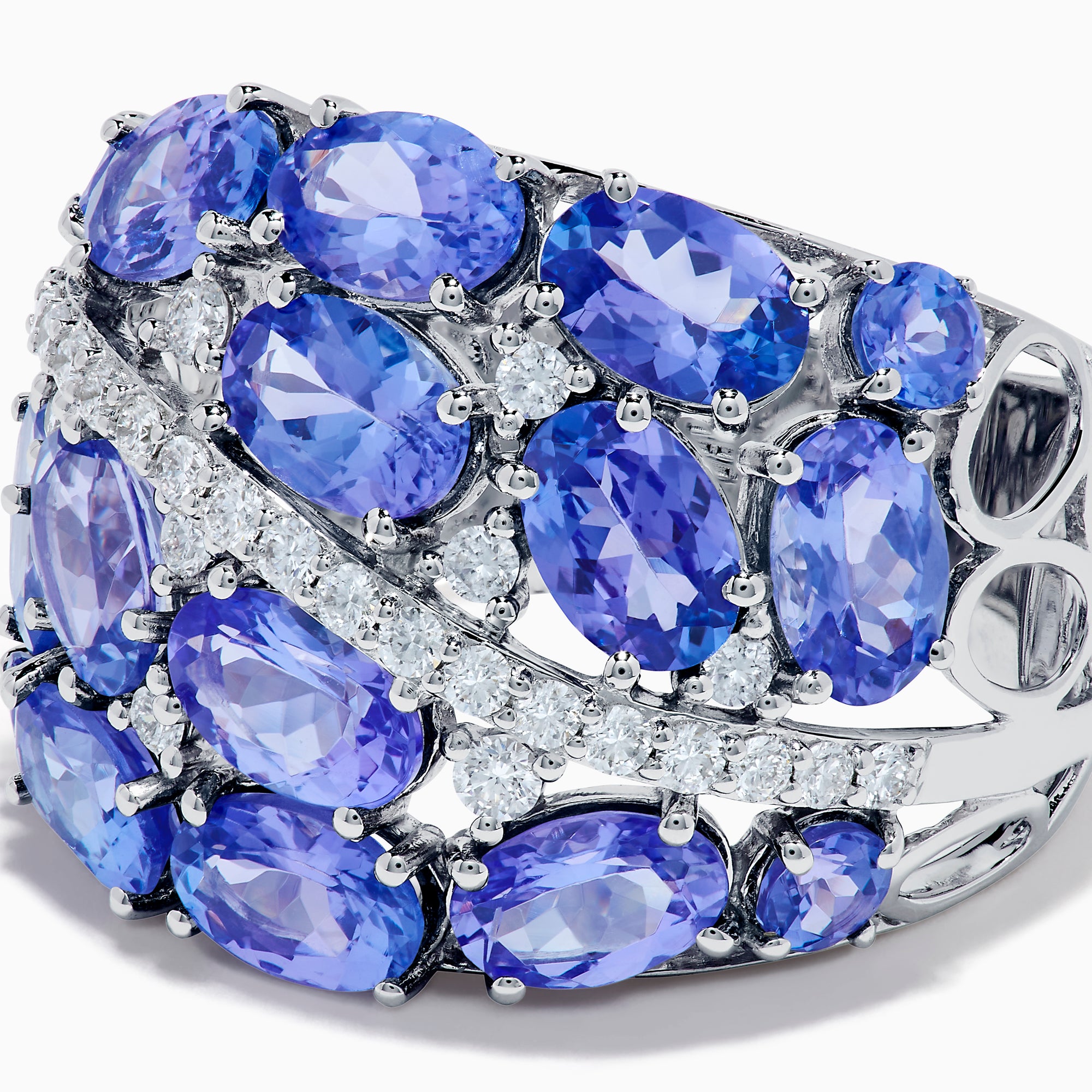 The 14K White Gold Tanzanite and Diamond Statement Ring features multiple oval blue-violet tanzanites and round white diamonds in an elegant, layered design.