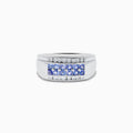 The Mens 925 Sterling Silver Tanzanite and Diamond Ring features a central row of round tanzanite gemstones accented by two rows of sparkling diamonds, all set in a wide, polished sterling silver band.