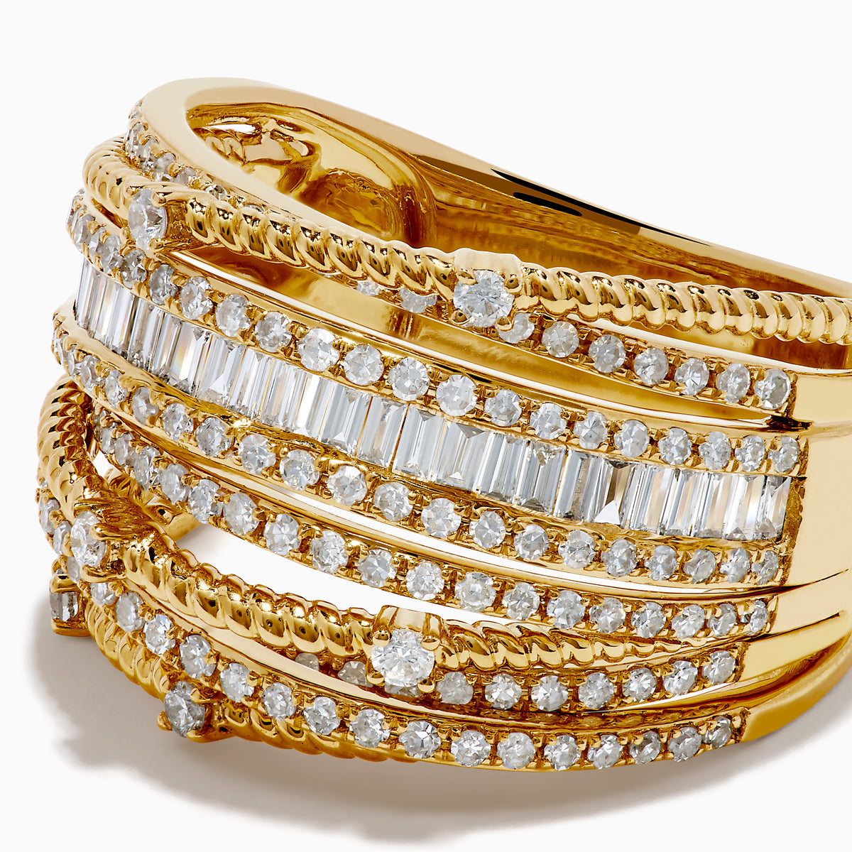 The 14K Yellow Gold Diamond Statement Crossover Ring features multiple overlapping bands with round and baguette diamonds, creating a striking, textured layered look against a white background.