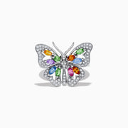 The Watercolors 14K Gold Multi Sapphire and Diamond Butterfly Ring features a silver butterfly with diamond-accented wings and colorful orange, green, blue, and purple sapphires at the center. Shown on a white background.